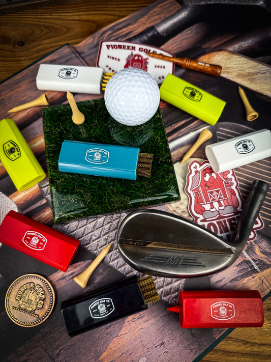 Golf club, ball, and various golf accessories on a wooden surface